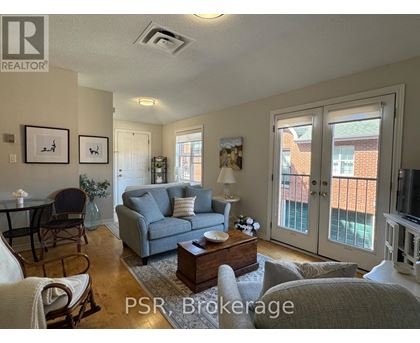 A living room with a couch, chairs, and a coffee table.