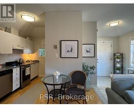 A kitchen with a table and chairs in the middle of the room.