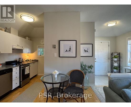 A kitchen with a table and chairs in the middle of the room.
