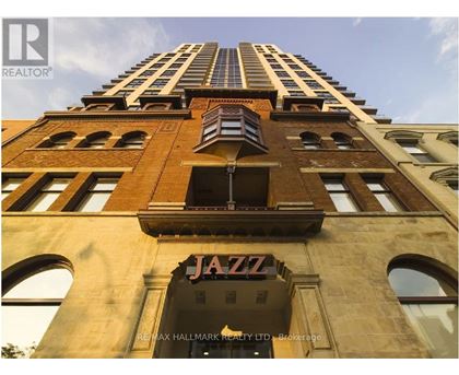 A tall building with a Jazz sign on the ground floor.