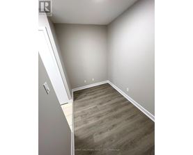 A room with a wooden floor and white walls.