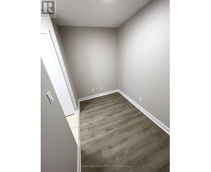 A room with a wooden floor and white walls.
