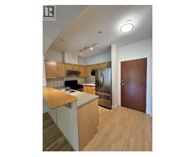 A kitchen with wooden cabinets and a counter top.