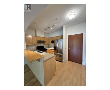 A kitchen with wooden cabinets and a counter top.