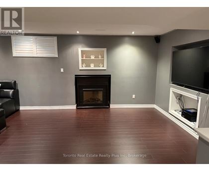 A living room with a fireplace and a television.
