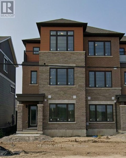 A multi-story residential building under construction with a clear sky in the background.