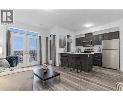 A modern kitchen with a large island and stainless steel appliances.