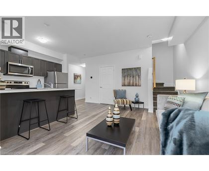 A modern kitchen with a bar stool and a dining table.