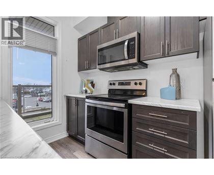 A modern kitchen with a stainless steel oven and microwave.