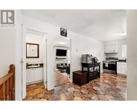 A kitchen with a tile floor and a white wall.