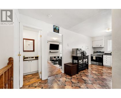 A kitchen with a tile floor and a white wall.