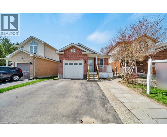 A house with a driveway and a car parked in front.