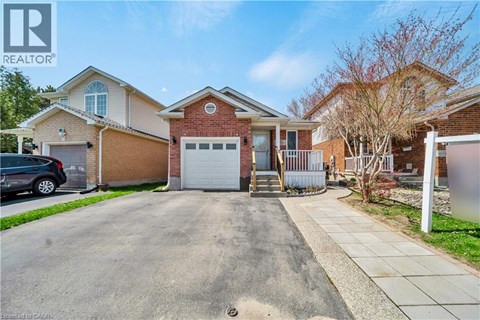 A house with a driveway and a car parked in front.