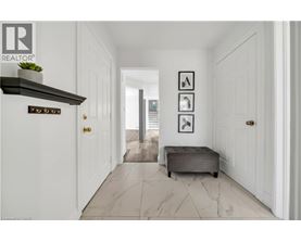 A hallway with a bench and pictures on the wall.