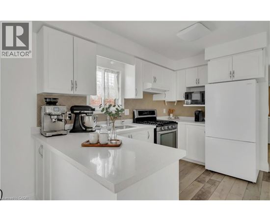 A white kitchen with a wooden tray on the counter.