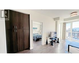 A bedroom with a bed and a table in it.