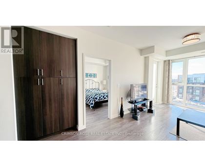 A bedroom with a bed and a table in it.