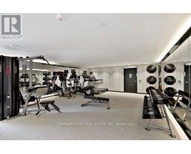 A well-equipped gym with a variety of exercise machines and weights.