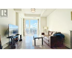 A living room with a flat screen TV and a couch.