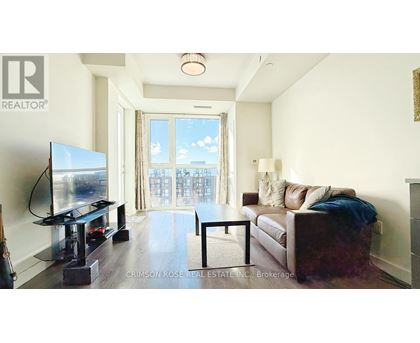 A living room with a flat screen TV and a couch.