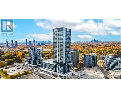 A cityscape with a large building in the foreground and a clear sky above.