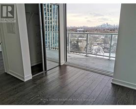 A room with a balcony view of a snowy landscape.