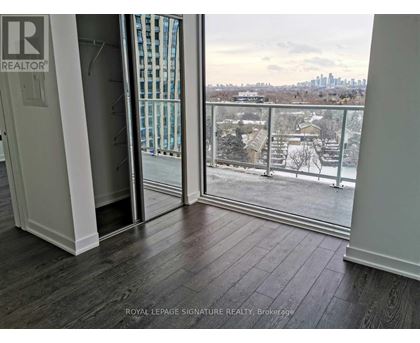 A room with a balcony view of a snowy landscape.