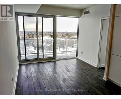 A room with a sliding glass door leading to a snowy landscape.