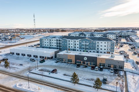 A large building with a parking lot in front of it.