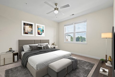 A bedroom with a large bed and two pictures on the wall.