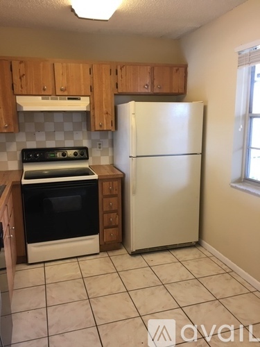 A kitchen with a stove, oven, and refrigerator.
