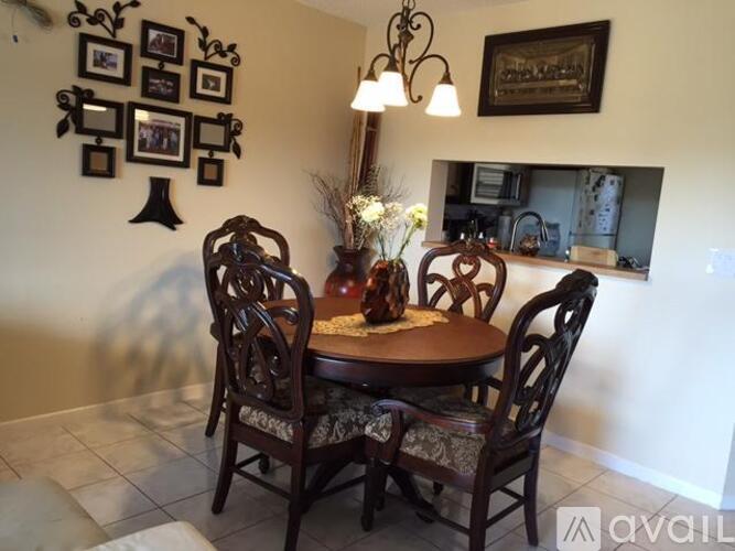 A dining room with a table and chairs.