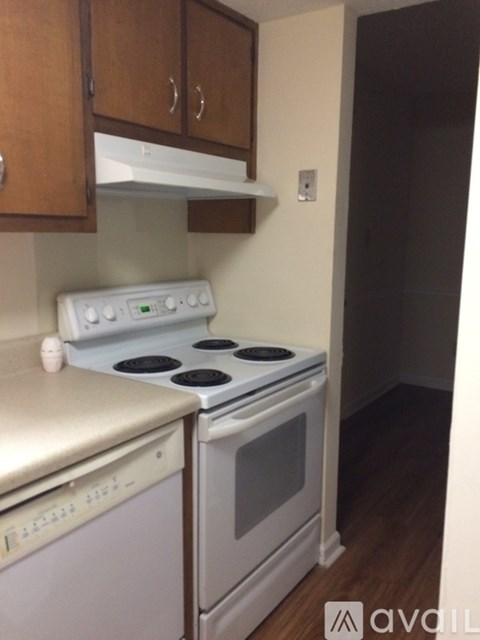 A white stove and dishwasher in a kitchen.