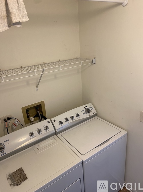 A white washing machine and dryer in a small laundry room.