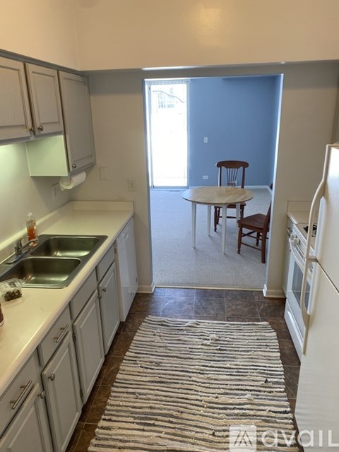 A kitchen with a table and chairs in it.