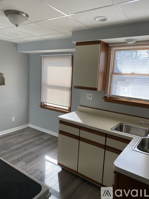 A kitchen with a stove top oven and a sink.