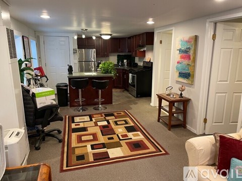 A kitchen with a bar and a dining table.