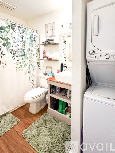 A small laundry room with a washer and dryer.