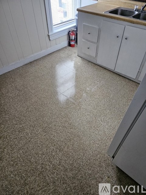 A kitchen with a white counter and cabinets.
