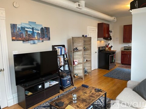 A living room with a wooden coffee table and a flat screen TV.