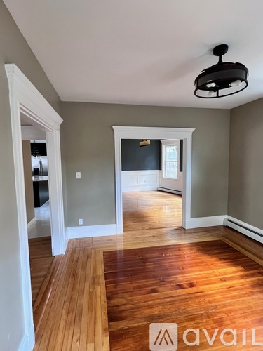 A room with wooden floors and a light fixture.