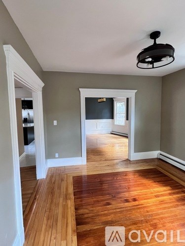 A room with wooden floors and a light fixture.
