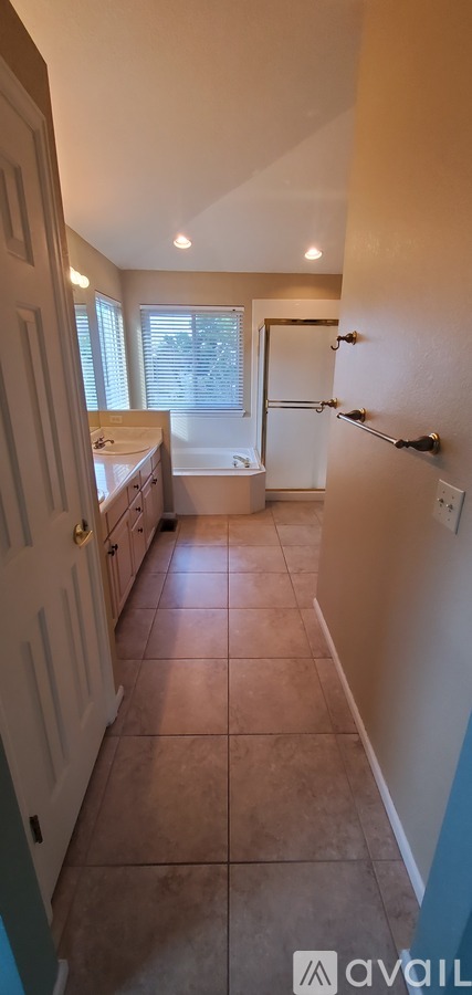 A bathroom with a white door and a window.