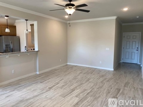 A spacious room with a fan and a door.