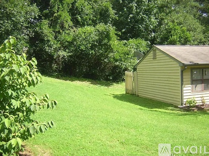 A small house with a green lawn in front of it.