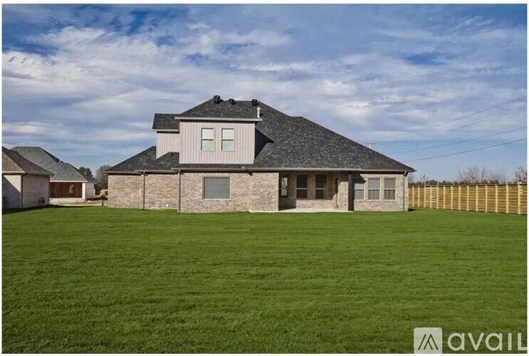 A house with a large lawn in front of it is for sale.
