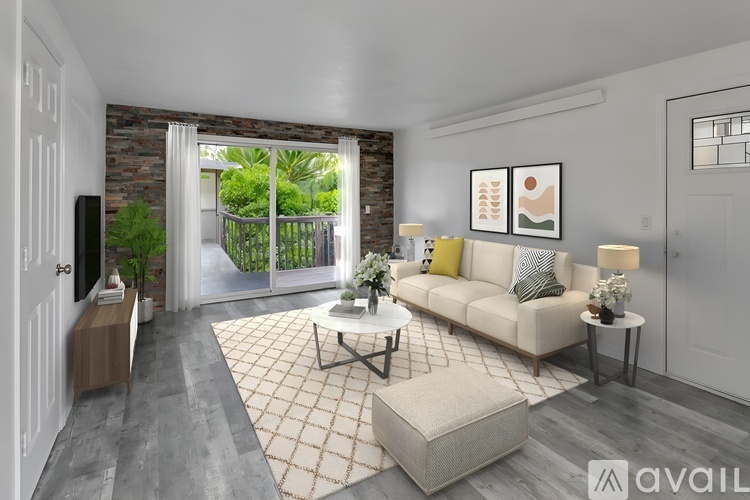 A living room with a white couch, a coffee table, and a television.
