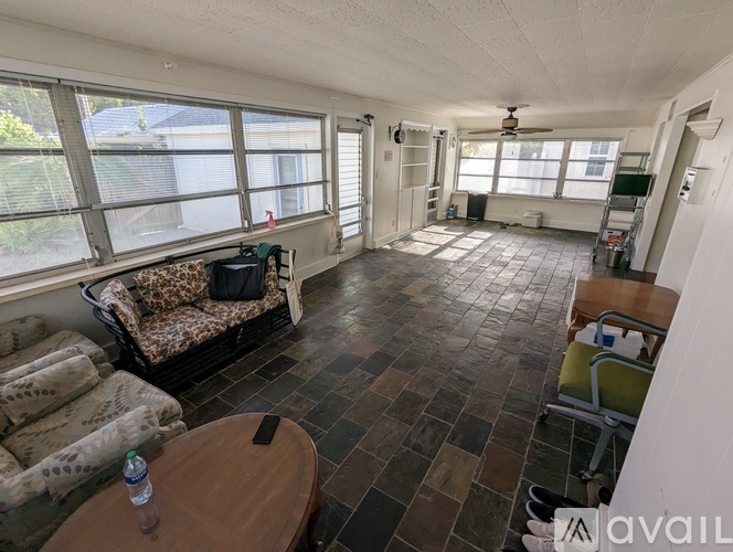 A living room with a couch, chair, and table.