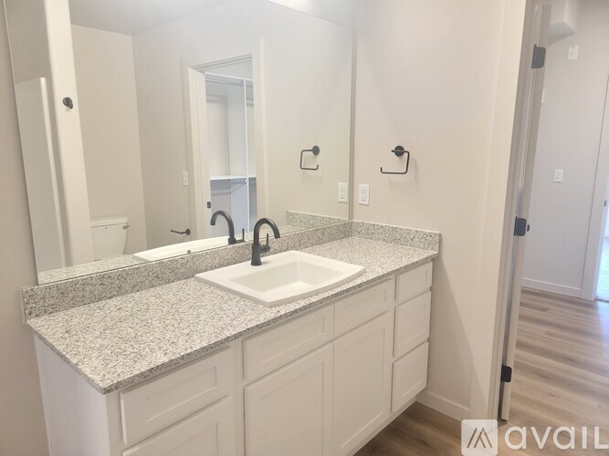 A bathroom with a sink and a mirror.