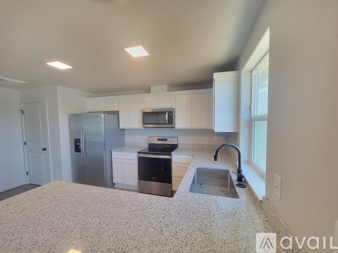 A kitchen with a sink and a refrigerator.